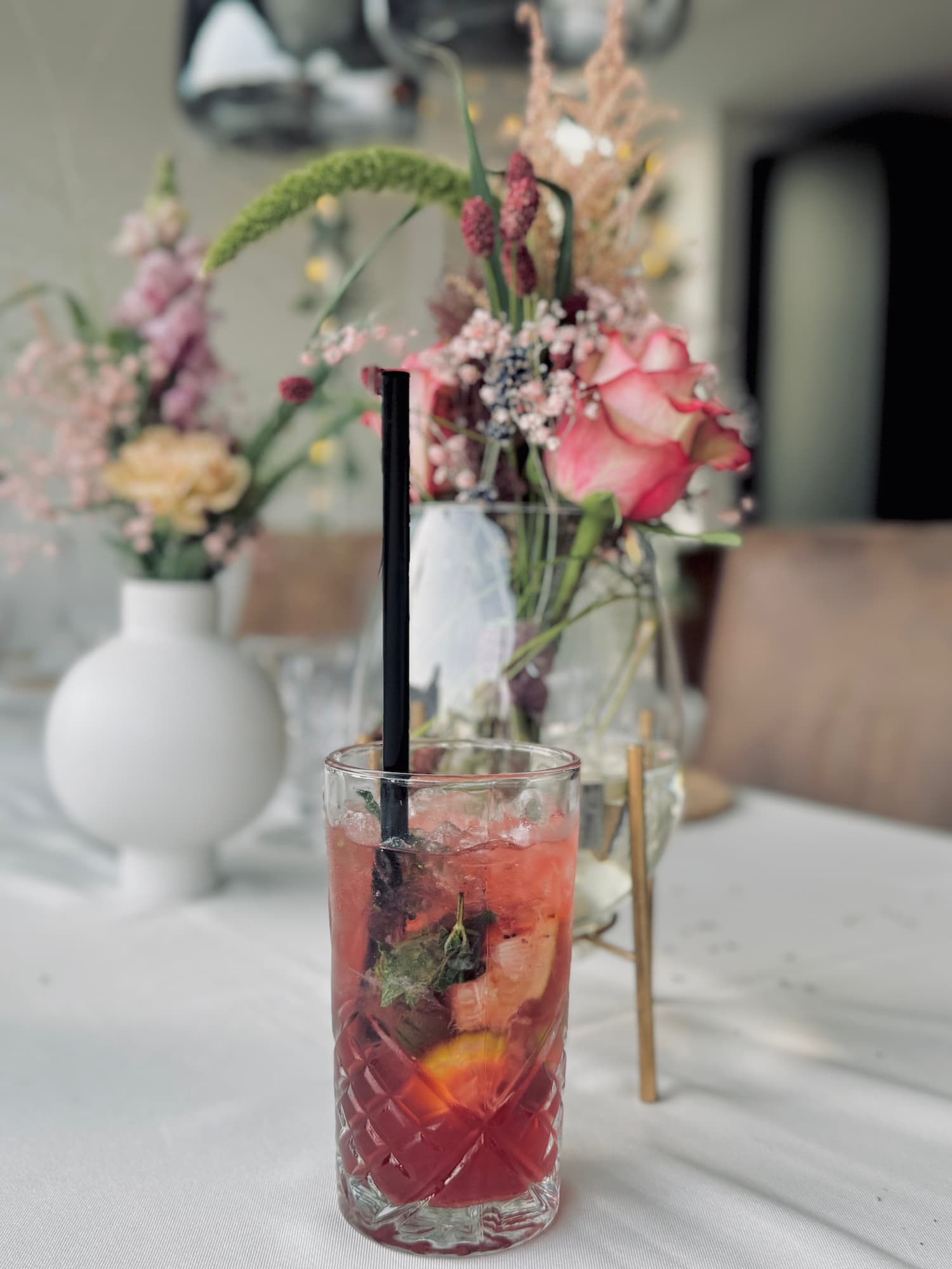 Cocktail on a wedding table decorated with flowers